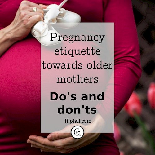 Pregnant woman holding baby shoes