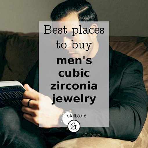 Stylish man sitting on a sofa reading a book - where to find men's cubic zirconia rings